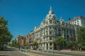 Building with flamboyant facade and people on street of Madrid