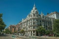 Building with flamboyant facade and people on street of Madrid