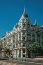 Building with flamboyant facade and people on street of Madrid