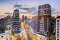 Madrid, Spain - July 26, 2016: Cityscape of the Gran Via with the Schweppes sign, historical buildings, traffic and night life tak Royalty Free Stock Photo