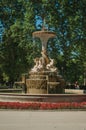 Fountain with statues and bushes in a park of Madrid