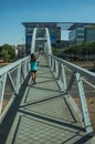 Little girl on footbridge for pedestrians over highway in Madrid