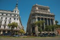 Buildings on the busy street with people and cars in Madrid