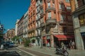 Old buildings with shops and people on a busy street of Madrid