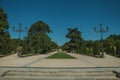 Pedestrian promenade with trees and streetlights in a park of Madrid