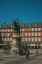 People on the Plaza Mayor with the statue of King Philip III in Madrid