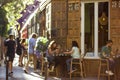 Madrid, Spain. July 1, 2022 People sitting on cafe bar terrace. Urban scene.