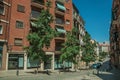 Building with bricks facade and trees on a quiet street in Madrid