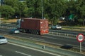 Truck on highway with traffic and SPEED LIMIT signpost in Madrid