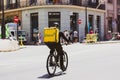 Madrid, Spain. June 1, 2022. Glovo courier delivery man with backpack rides bike