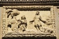 Scene carved in stone on facade of old house in Cordoba, Spain