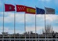 Madrid, Spain- March 6, 2022: Group of flags on the flagpoles