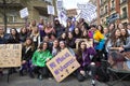 Group of teenage girls with painted faces holding different protest banners during the manifestation of Women`s Day in Madrid