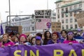 Head of the feminist march and group of protesters concentrated with a protest banner in one of the main streets of central Madrid