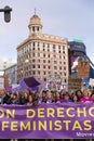 Head of the feminist march and group of protesters concentrated with a protest banner in one of the main streets of central Madrid Royalty Free Stock Photo