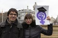 Man and woman holding placard with the feminist symbol during the Women`s Day demonstration in the city center of Madrid, Spain