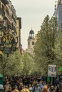 Madrid, Spain. March 21, 2017. People walking along blooming cherry trees from Plaza de Isabel II along Arenal street (Calle del