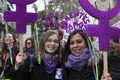 Two brazilian girls holding banner with the feminist symbol during the Women`s Day demonstration in the city center of Madrid