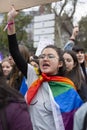 Young woman with the LGBT flag during the Women`s Day demonstration in the city center of Madrid, Spain, on March 8, 2020