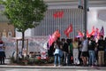 Group of people protesting with CCOO, UGT and Juventud comunista flag in front of a H&M shop