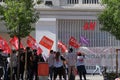 Group of people protesting with CCOO, UGT and Juventud comunista flag in front of a H