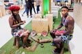 Madrid, Spain - May 20, 2021: Two actors wearing traditional Mayan clothing in a Mexican tourism show in Fitur