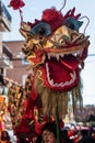 Chinese New Year parade in Usera neighborhood, Madrid. Spain. Traditional dragon mask head carried by several people