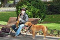 Madrid, Spain -- Nov 3, 2017: Street musician with dog Royalty Free Stock Photo