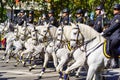 Madrid, Spain, October 12, 2022: Group of military riders mounted on horseback in line with beautiful white horses.