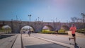 A man is running in front of the Toledo medieval bridge at Madrid Rio park in Spain Royalty Free Stock Photo