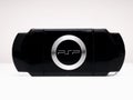 Rear view of the famous Sony PSP Playstation Portable video game console in black on a white background