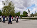 Madrid, Spain, 12.04.2022. Segway tour stopping in front of the Fountain of the Fallen Angel in Retiro Park.