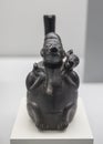 Chimu vessel depicting a man carriying on back an animal