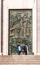 MADRID, SPAIN - SEPTEMBER 26, 2017: People in the background of a bas-relief on the door of the Gothic Revival of Santa Maria la R