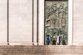 MADRID, SPAIN - SEPTEMBER 26, 2017: People in the background of a bas-relief on the door of the Gothic Revival of Santa Maria la R