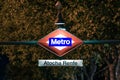 Sign indicating the metro station of the Atocha train station illuminated by a small lantern