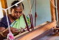 Woman weaves fabric on a traditional loom Royalty Free Stock Photo