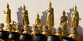 Six Buddha statues in different postures and monk dolls with their charity boxes