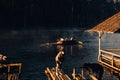 Mae Hong Sorn, Thailand - December 17, 2021 : Beautiful lake over the misty river at sunrise with traveler on the Bamboo raft.