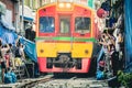 Mae Klong Railway Market. Train passing a few centimeters from people and stalls. Royalty Free Stock Photo