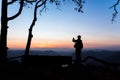 Mae Ping river view point. Silhouette woman taking a mountain sunrise photograph by mobile phone Royalty Free Stock Photo