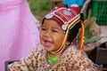 MAE SALONG, THAILAND - DECEMBER 17. 2017: Portrait of a happy toddler baby from Akha hill tribe in a shopping box on market with