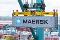 Maersk owned container loaded by the gantry crane on the container ship.