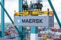 Maersk owned container loaded by the gantry crane on the container ship.