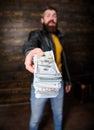 Mafia business. Man brutal bearded hipster wear leather jacket and hold cash money. Illegal profit and black cash. Guy Royalty Free Stock Photo