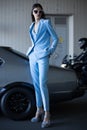 Mafia lady outside japonese car in the sea port. Fashion girl standing next to a retro sport car Royalty Free Stock Photo