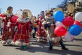 Children in traditional clothes of indigenous peoples of the Magadan region dance on the street of the city