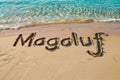 Magaluf, Spain written in the sand on a beach. Spanish tourism and vacation background