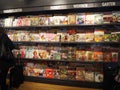 Magazine shelf in train station bookstore with woman, travel magazines, handicrafts, hobbies, garden