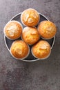 Magdalenas are the Spanish version of muffins or cupcakes and originate in Spain closeup in the plate. Vertical top view